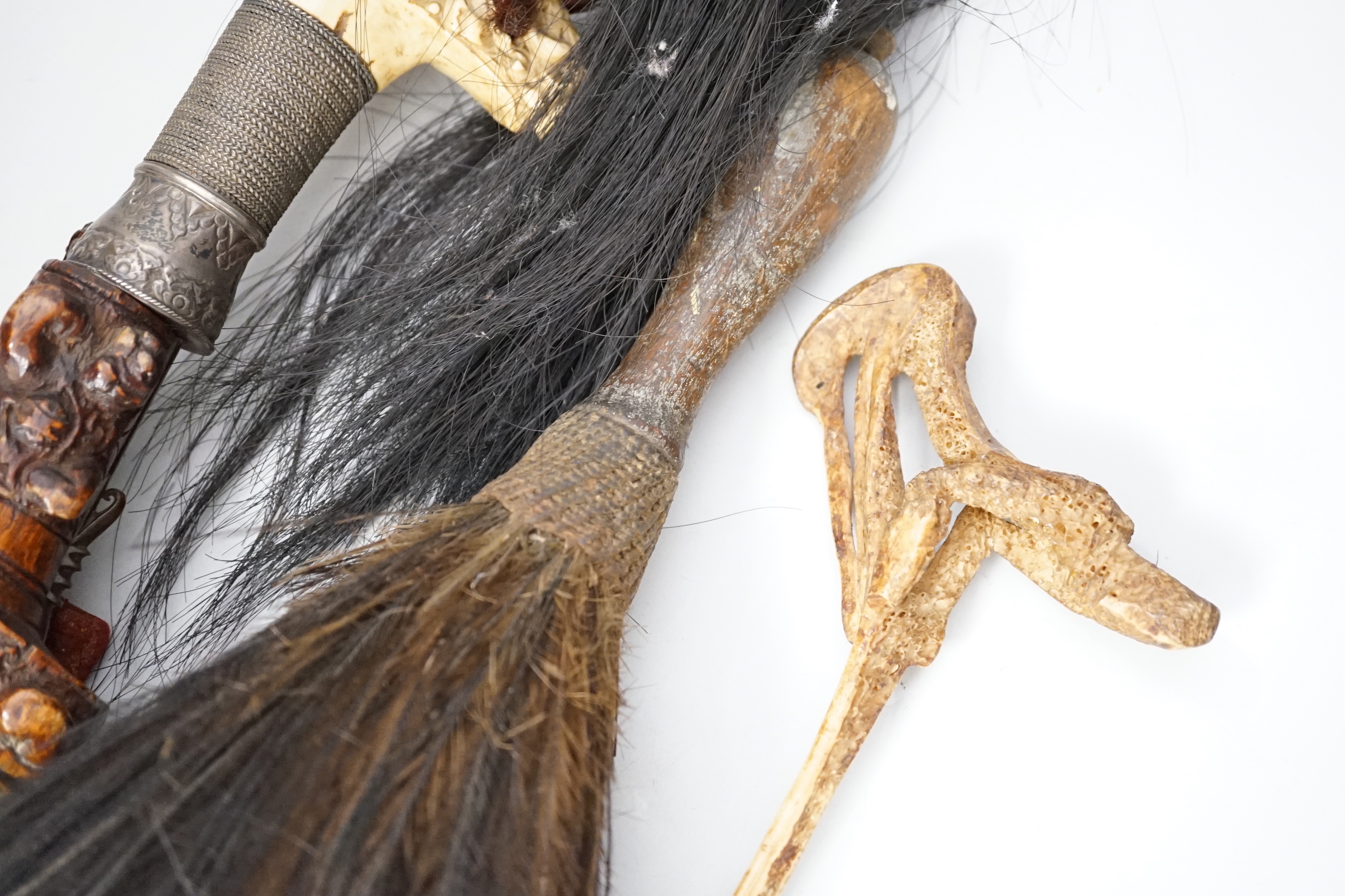 A Borneo 'headhunter's sword', a bone carving and feather swot (3), sword 77 cm long